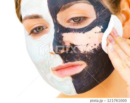 Girl remove black white mud mask from face Girl remove black white mud mask from face 121761000