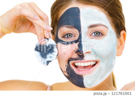 Girl remove black white mud mask from face 121761001