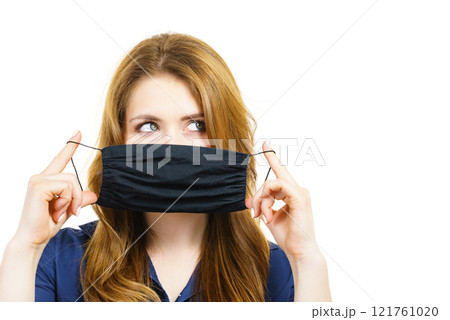 Woman using protective face mask. 121761020