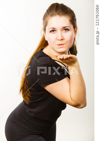 Portrait of happy attractive woman sending air kiss Portrait of happy attractive woman sending air kiss 121761060