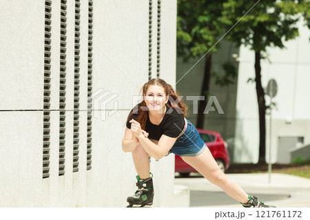 Young woman fast riding roller skates 121761172