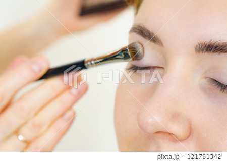 Makeup artist applying eye make up Makeup artist applying eye make up 121761342