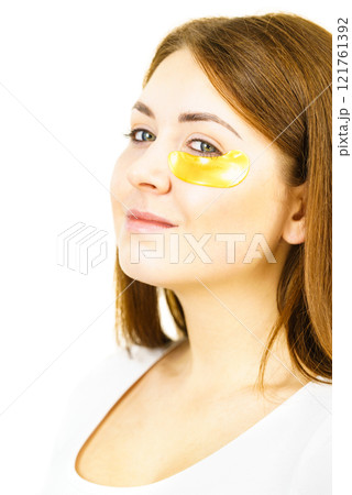 Woman with gold patches under eyes 121761392