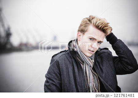 Portrait of fashion model guy outdoors 121761481