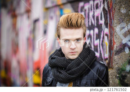 Fashion male portrait on graffiti wall Fashion male portrait on graffiti wall 121761502