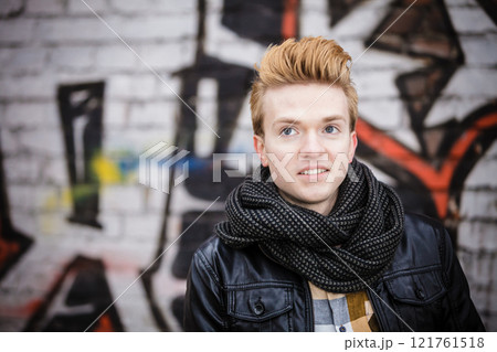 Fashion male portrait on graffiti wall 121761518
