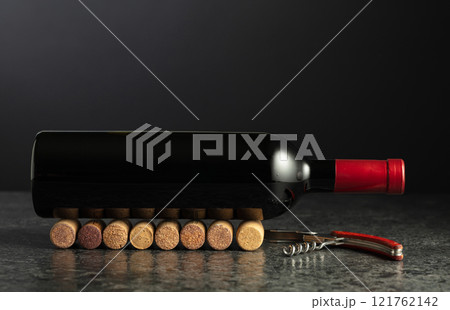 Corkscrew and bottle of red wine. 121762142
