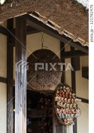 Traditional Japanese sugidama hanging outside. Concept of sake brewing, cultural symbols, and rustic tradition Traditional Japanese sugidama hanging outside. Concept of sake brewing, cultural symbols, and rustic tradition 121762476