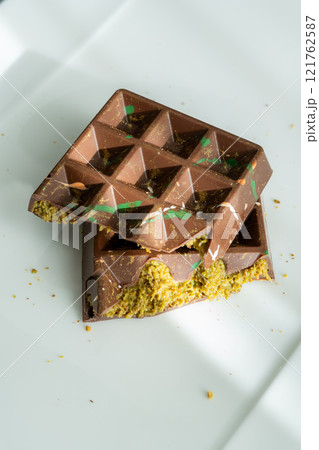 Dubai chocolate bar with pistachio paste, tahini and kataifi dough. Confectionery and sweets. Dubai chocolate bar with pistachio paste, tahini and kataifi dough. Confectionery and sweets. 121762587
