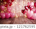 A Valentine's Day background with heart-shaped balloons in shades of pink with bokeh background and wooden floor. Valentine's day background. 121762595