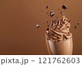 Side view of mocha or chocolate mousse dessert with smooth texture with crushed chocolate in motion, soft brown background. Color trend concept, color of the year 2025. Banner with copy space. 121762603