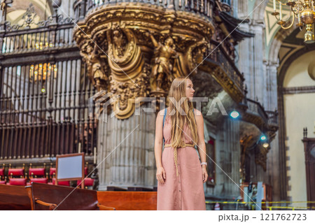 Female tourist exploring the Metropolitan Cathedral in Mexico City. Woman admiring the architecture and history of Mexico's iconic landmark. Concept of cultural heritage, religious tourism, and travel Female tourist exploring the Metropolitan Cathedral in Mexico City. Woman admiring the architecture and history of Mexico's iconic landmark. Concept of cultural heritage, religious tourism, and travel 121762723