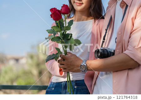 Romantic valentine day surprise for couple with roses outdoor setting lifestyle photography joyful mood 121764318