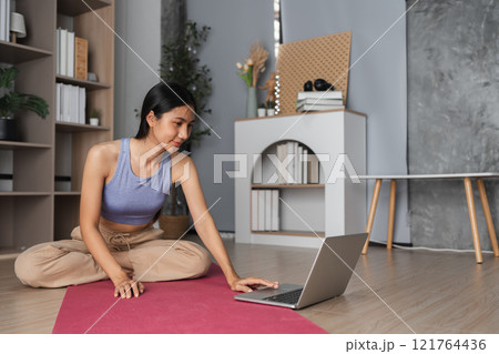 Young Woman Practicing Yoga and Meditation Indoors for Relaxation and Mindfulness in a Modern Home Setting Young Woman Practicing Yoga and Meditation Indoors for Relaxation and Mindfulness in a Modern Home Setting 121764436