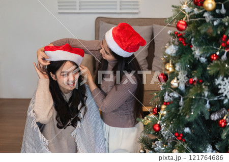 Joyful Young Couple Celebrating Christmas Together with Festive Decorations and Holiday Spirit Joyful Young Couple Celebrating Christmas Together with Festive Decorations and Holiday Spirit 121764686