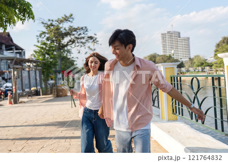 Valentine's day celebration riverside walk couple enjoying love urban environment joyful viewpoint romantic concept Valentine's day celebration riverside walk couple enjoying love urban environment joyful viewpoint romantic concept 121764832