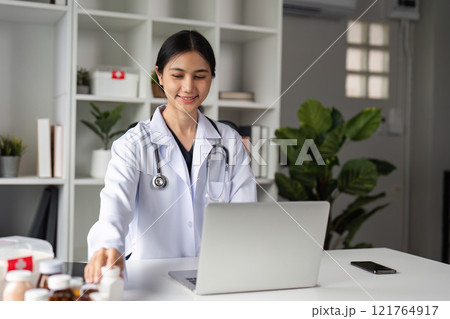 Confident Female Doctor Recommends Medication Online via Video Call in Modern Medical Office Setting Confident Female Doctor Recommends Medication Online via Video Call in Modern Medical Office Setting 121764917