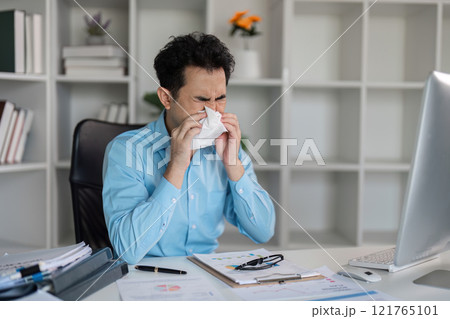Unwell professional catches flu at work office environment emotional content close-up viewpoint on fever symptoms Unwell professional catches flu at work office environment emotional content close-up viewpoint on fever symptoms 121765101