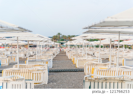 Placed in a rows lot of deck chairs on the beach at morning. 121766253