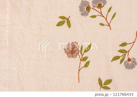 Light beige fabric with blue flowers on it as a background. Light beige fabric with blue flowers on it as a background. 121766435