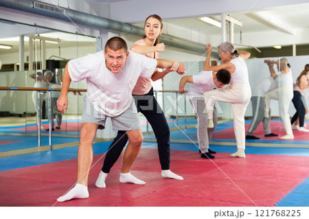 Young woman exercising elbow strike during self-protection training Young woman exercising elbow strike during self-protection training 121768225