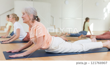 Senior woman exercising stretching workout Senior woman exercising stretching workout 121768907