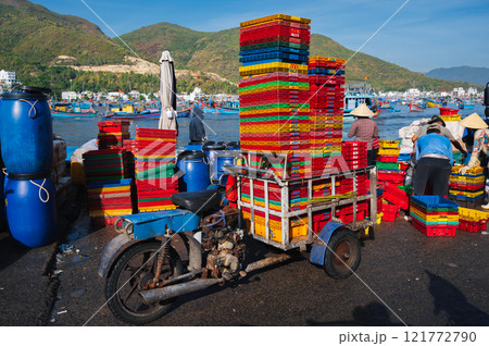 Vietnamese people at the fish market load empty boxes after selling fresh fish Vietnam 121772790