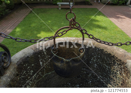 Old well bucket with rusty chain, life concept from a century ago. 121774553