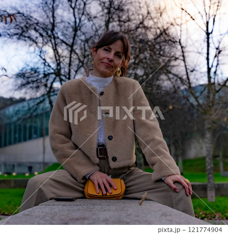 Woman sitting in the park 121774904