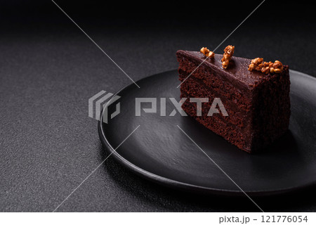 Piece of sweet chocolate cake with nuts Piece of sweet chocolate cake with nuts 121776054