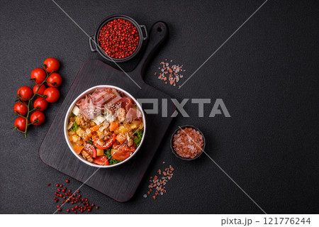 Appetizing salad with prosciutto, pumpkin, cheese and tomatoes 121776244