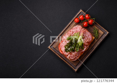 Focaccia with salami, cheese, tomatoes, arugula, salt, spices and herbs Focaccia with salami, cheese, tomatoes, arugula, salt, spices and herbs 121776344
