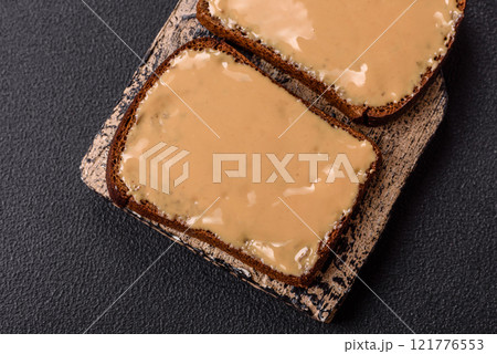 Sandwiches with toast bread, peanut butter and raspberry or strawberry jam Sandwiches with toast bread, peanut butter and raspberry or strawberry jam 121776553