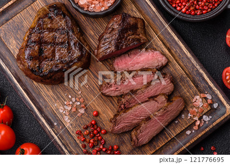 Juicy beef steak baked on the grill with salt, spices and herbs Juicy beef steak baked on the grill with salt, spices and herbs 121776695