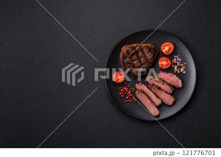 Juicy beef steak baked on the grill with salt, spices and herbs 121776701