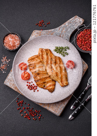 Juicy chicken fillet baked on the grill with salt, spices and herbs Juicy chicken fillet baked on the grill with salt, spices and herbs 121776761