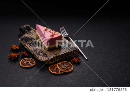 Piece of sweet cheesecake with pink cream cheese of raspberry or strawberry flavor 121776878