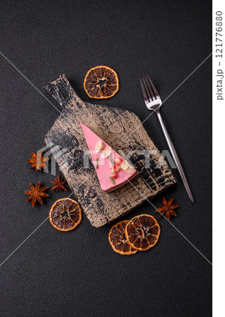Piece of sweet cheesecake with pink cream cheese of raspberry or strawberry flavor Piece of sweet cheesecake with pink cream cheese of raspberry or strawberry flavor 121776880