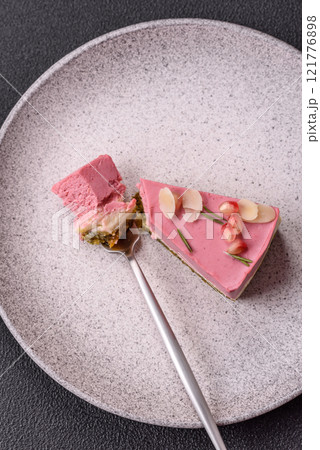 Piece of sweet cheesecake with pink cream cheese of raspberry or strawberry flavor Piece of sweet cheesecake with pink cream cheese of raspberry or strawberry flavor 121776898