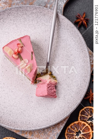 Piece of sweet cheesecake with pink cream cheese of raspberry or strawberry flavor Piece of sweet cheesecake with pink cream cheese of raspberry or strawberry flavor 121776901