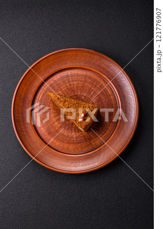 Piece of sweet layered honey cake 121776907