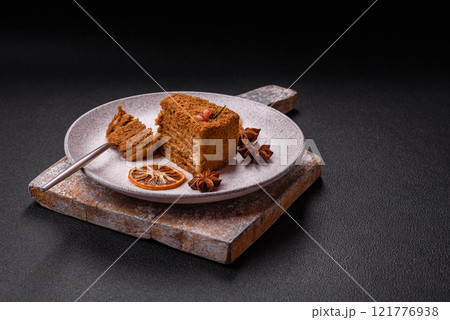 Piece of sweet layered honey cake Piece of sweet layered honey cake 121776938