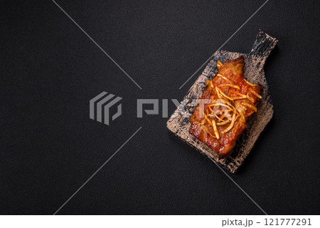 Pork or beef ribs with salt, spices and herbs baked on the grill Pork or beef ribs with salt, spices and herbs baked on the grill 121777291