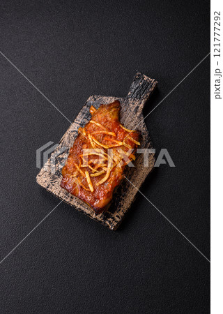 Pork or beef ribs with salt, spices and herbs baked on the grill 121777292