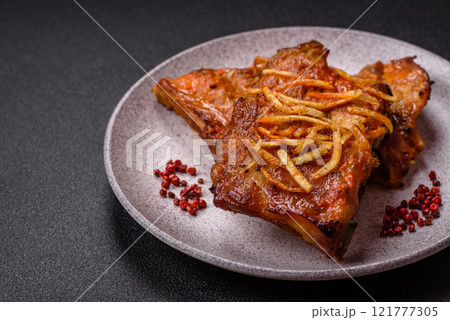 Pork or beef ribs with salt, spices and herbs baked on the grill Pork or beef ribs with salt, spices and herbs baked on the grill 121777305