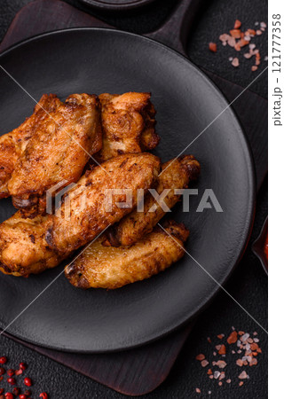 Grilled chicken wings with salt, spices and herbs Grilled chicken wings with salt, spices and herbs 121777358