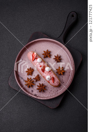 Sweet eclair or profiterole with strawberry custard Sweet eclair or profiterole with strawberry custard 121777425