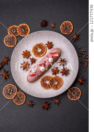 Sweet eclair or profiterole with strawberry custard Sweet eclair or profiterole with strawberry custard 121777436