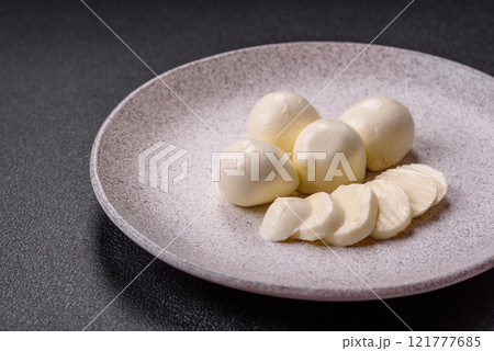 Delicious fresh mozzarella cheese with tomatoes, salt and spices Delicious fresh mozzarella cheese with tomatoes, salt and spices 121777685