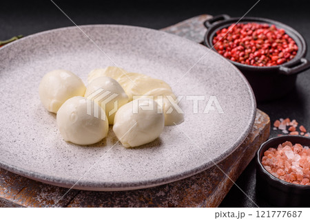 Delicious fresh mozzarella cheese with tomatoes, salt and spices Delicious fresh mozzarella cheese with tomatoes, salt and spices 121777687